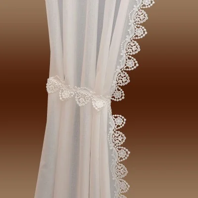 Ein durchsichtiger, hellbeiger Vorhang wird auf eine Seite gezogen und mit einem passenden Spitzenband befestigt. Der Vorhang hat einen detaillierten weißen Spitzenbesatz entlang seiner Kante. Der Hintergrund zeigt einen sanften Farbverlauf, der von Dunkelbraun zu Hellbraun übergeht.