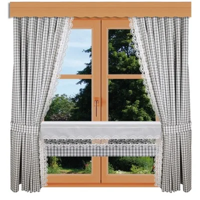 Ein holzgerahmtes Fenster mit Blick auf grüne Laubbäume. Das Fenster ist mit grau-weiß karierten Vorhängen mit weißer Spitze verziert, einschließlich eines passenden Volants und eines spitzenbesetzten Halbvorhangs im unteren Bereich.